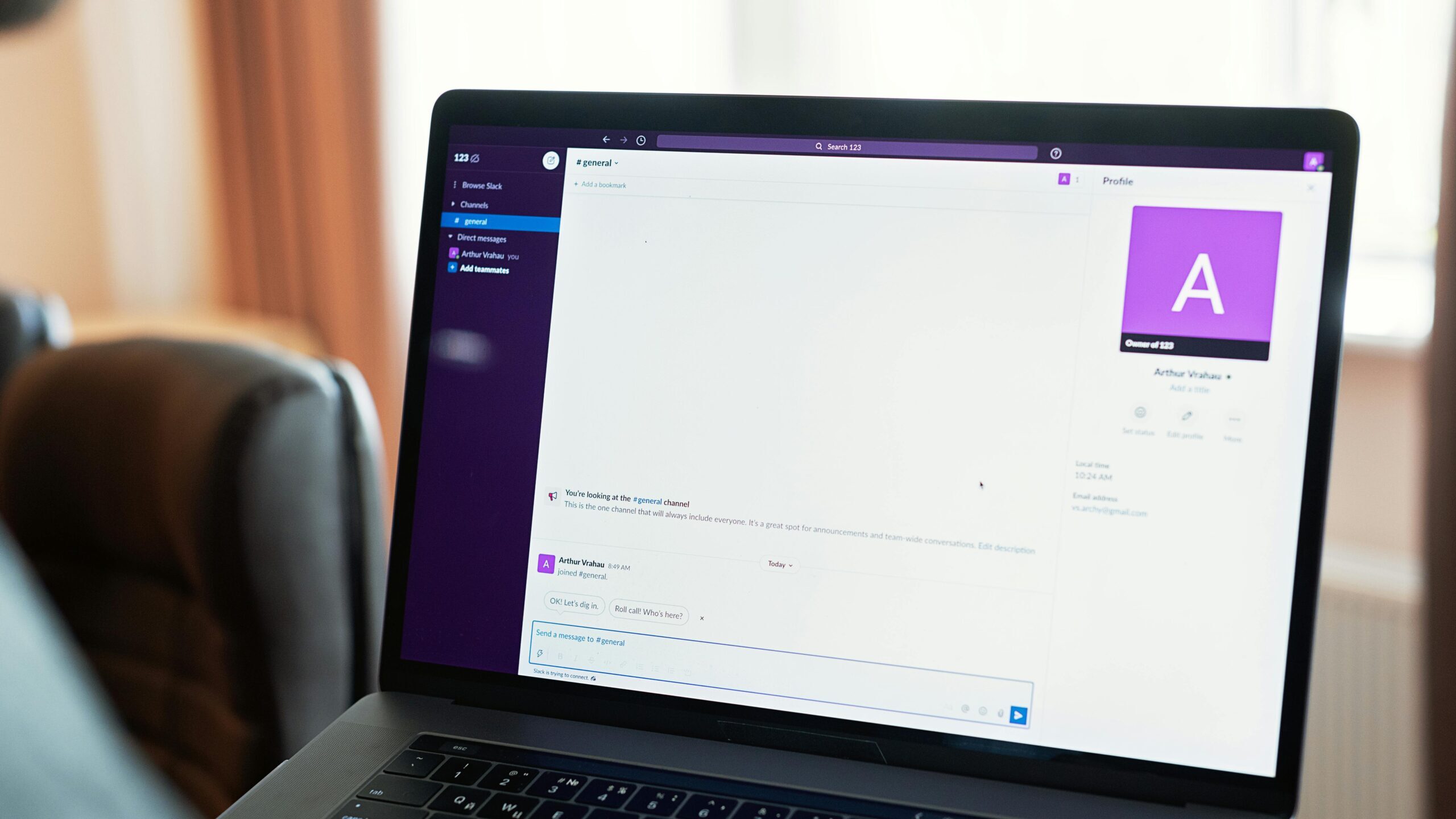 Person using a laptop with an online communication platform, showcasing modern work tech.